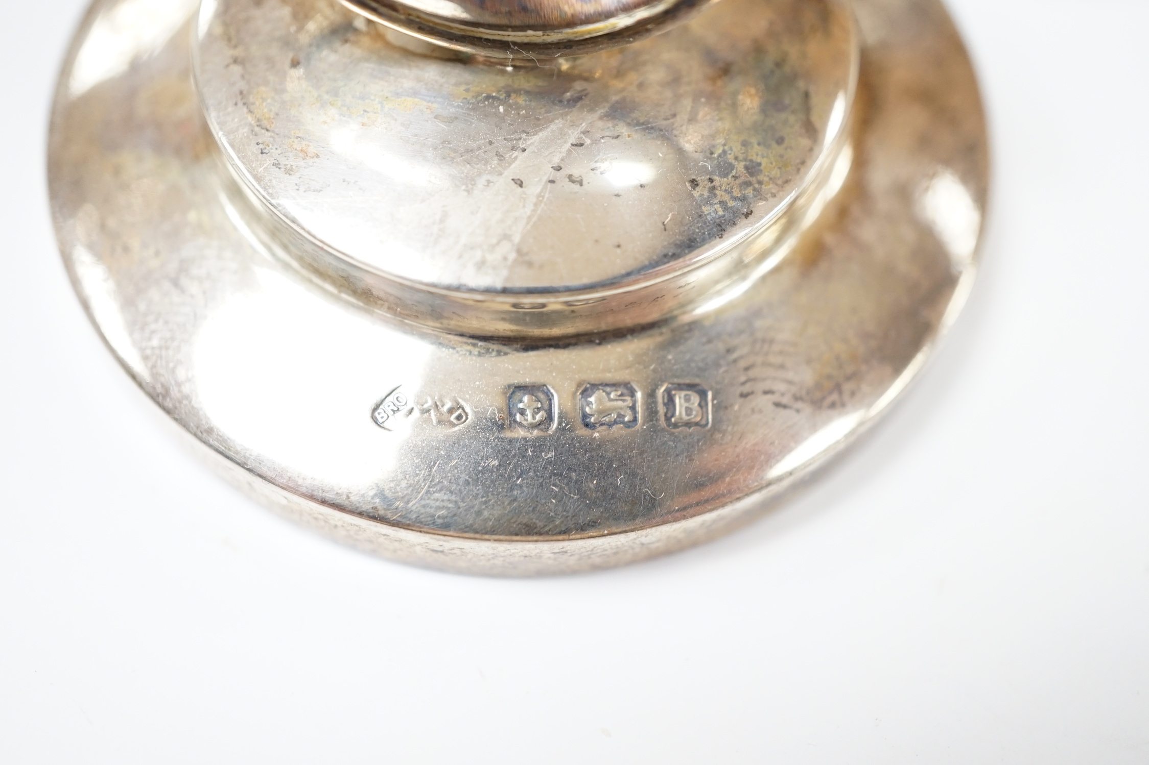 A set of four George V silver menu holders, each with inset painted panel of a wild bird, Adie Bros. Ltd, Birmingham, 1926, base diameter 5cm.